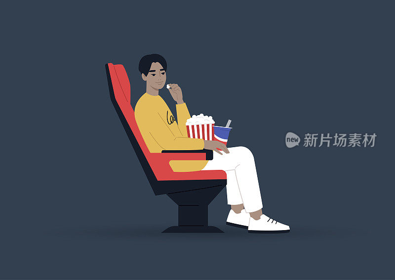 年轻男性亚洲人在电影院吃零食和看电影，娱乐概念