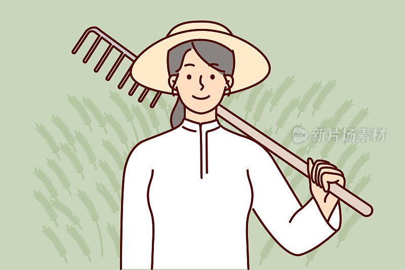 农妇在完成种植作物的土壤准备后，肩上扛着耙子