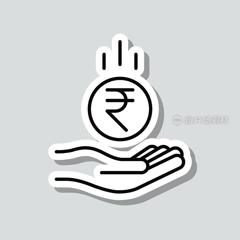 印度卢比硬币落在手里。图标贴纸在灰色背景