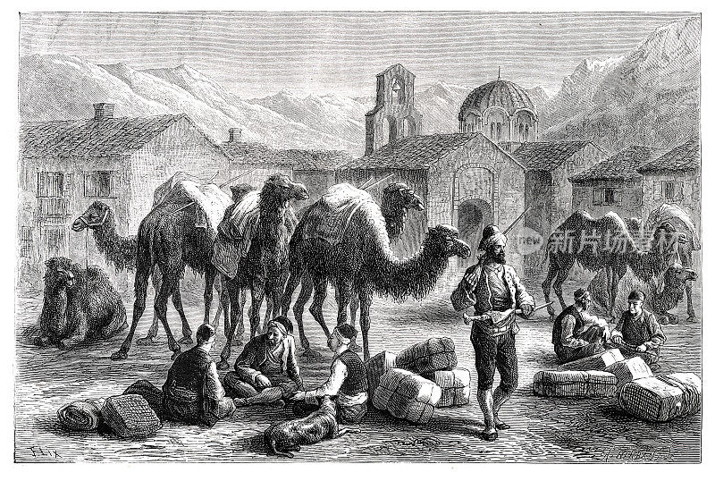 1877年，人们带着骆驼在非洲沙漠的商队旅馆休息