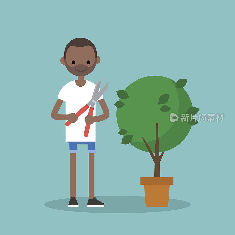 一个年轻的黑人正在用修枝机修剪灌木