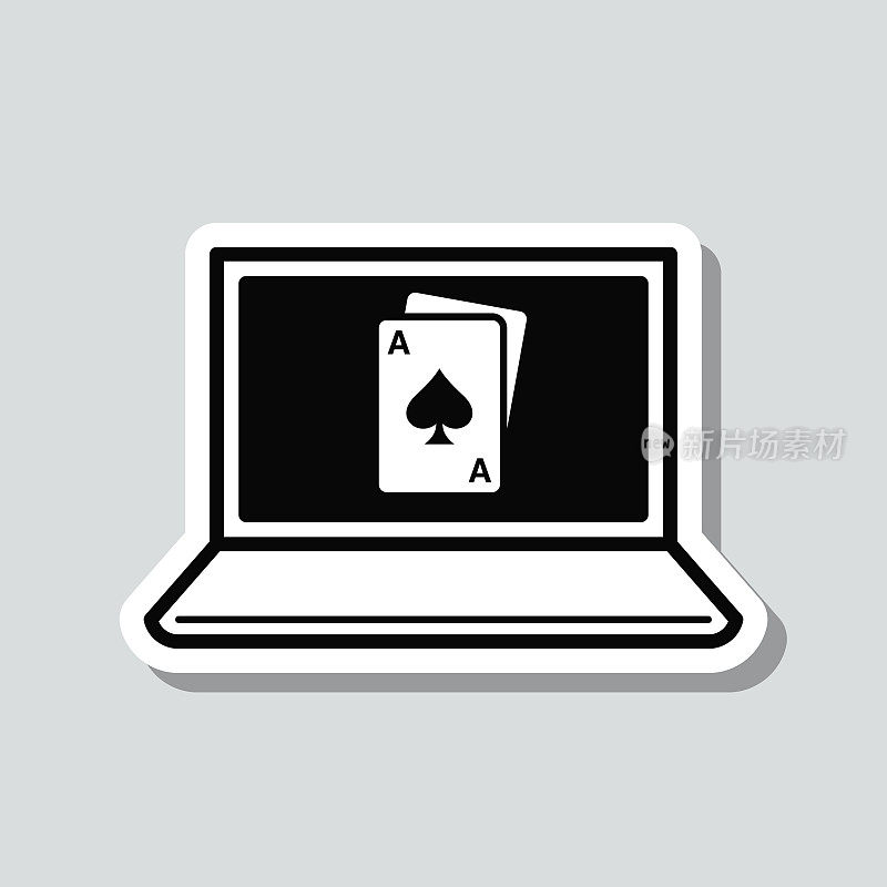 带扑克牌的笔记本电脑。图标贴纸在灰色背景