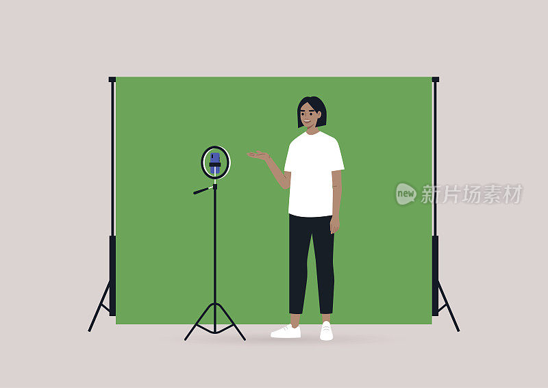 一名年轻的白人女性博主用三脚架、手机和色度键屏幕录制视频