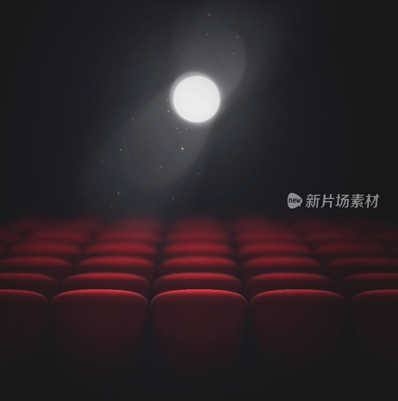 电影放映机照亮红色的电影院座位