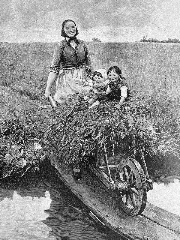 母亲推着干草收获手推车，孩子们载着稻草过河