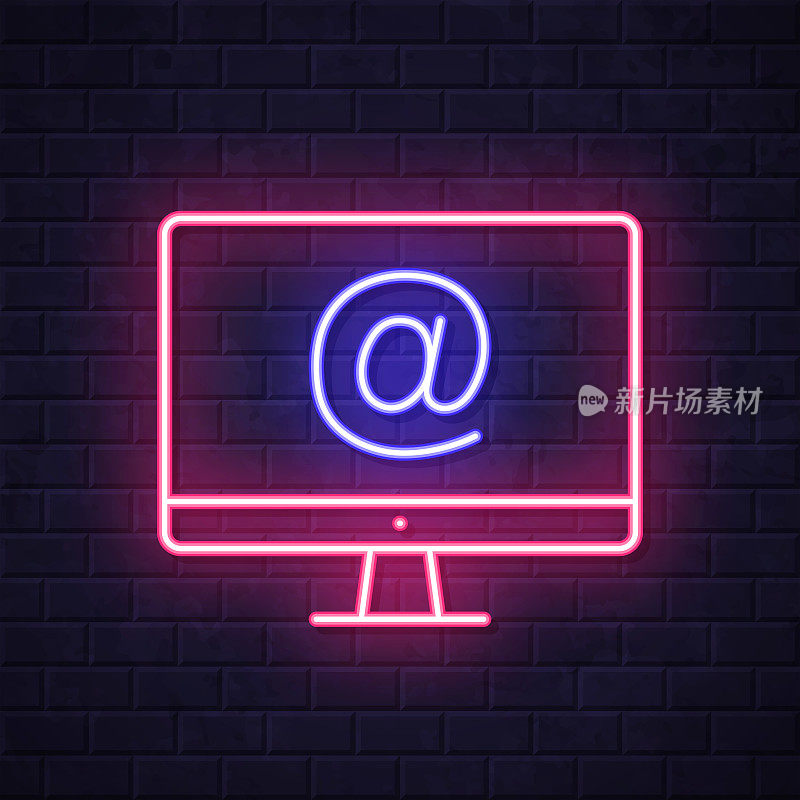 带有At符号的台式计算机。在砖墙背景上发光的霓虹灯图标