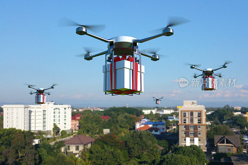 带着白色礼盒的无人机飞过小镇上空。