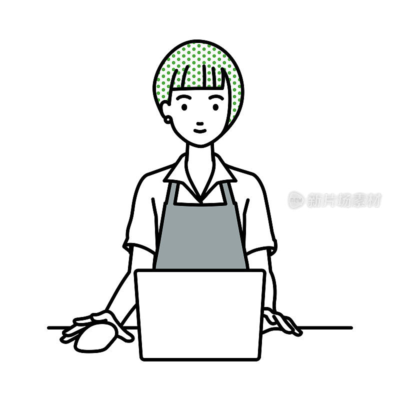 一个穿着咖啡吧围裙的女人在她的办公桌上使用笔记本电脑