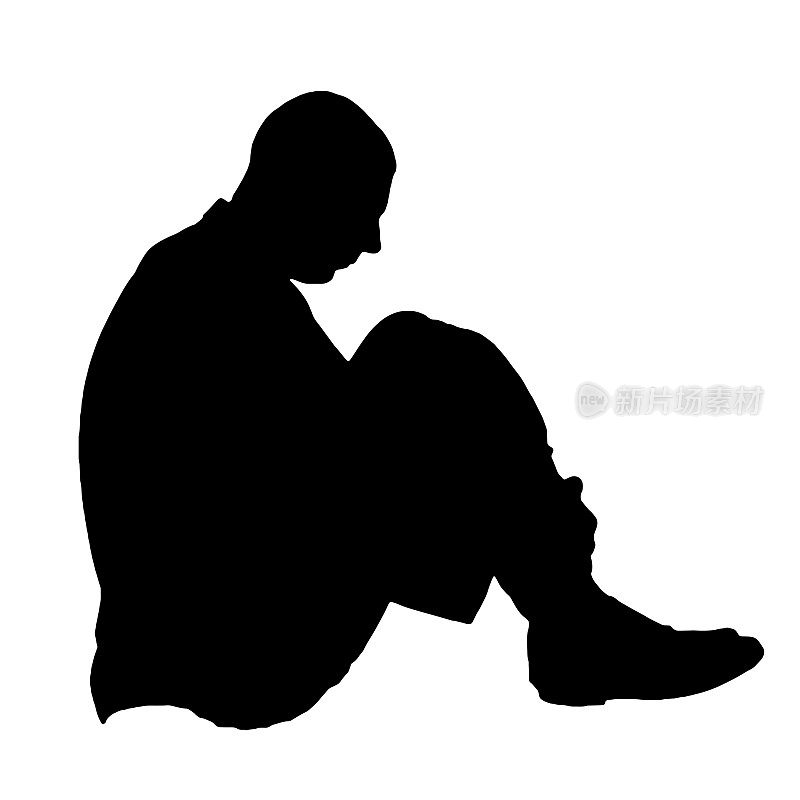 一个孤独悲伤的人坐在地板上，把腿收起来，他经历了抑郁、压力和悲伤。抑郁，压力的概念