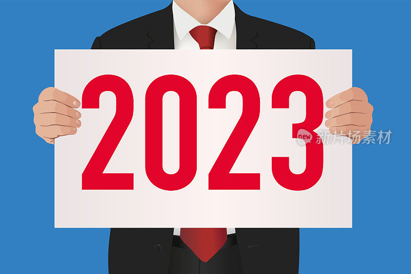 一名西装商人举着白色牌子，上面写着2023年。