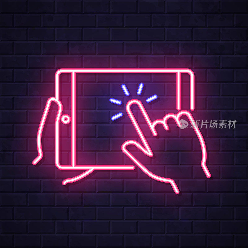手持触摸屏平板电脑。在砖墙背景上发光的霓虹灯图标