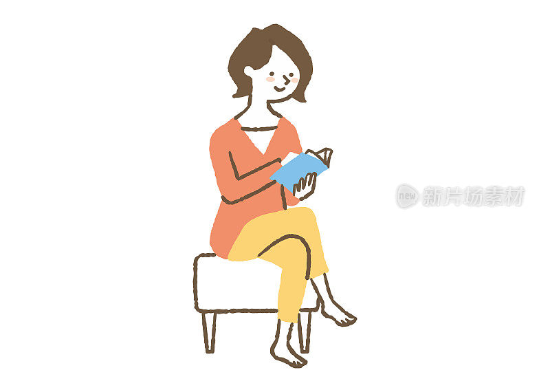 一个女人坐在椅子上读彩色书