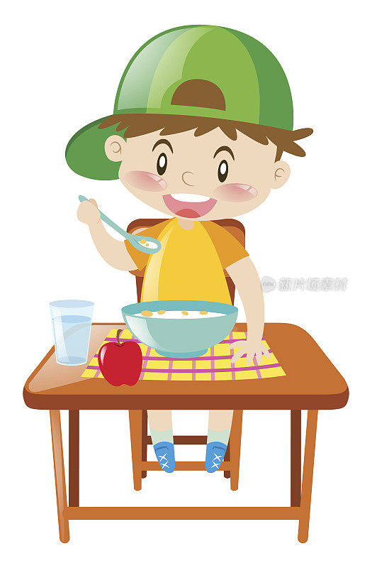 小男孩在餐桌上吃早餐