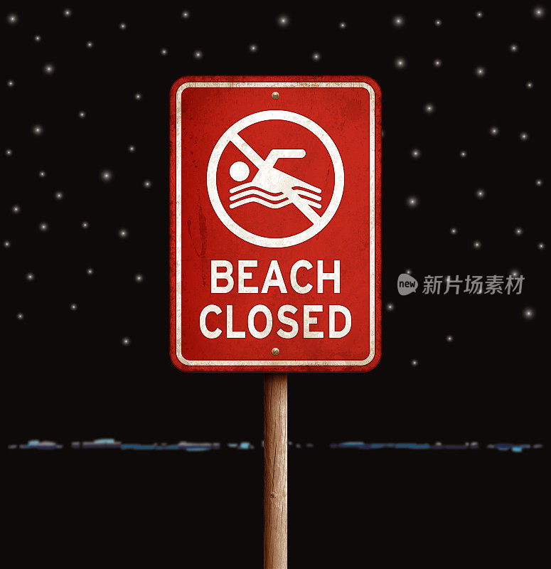 红色“海滩关闭”警告标志，夜间有海水