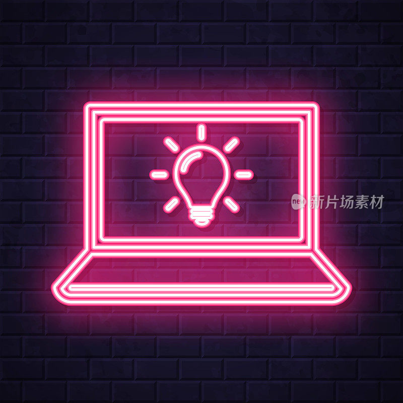 带灯泡的笔记本电脑。在砖墙背景上发光的霓虹灯图标