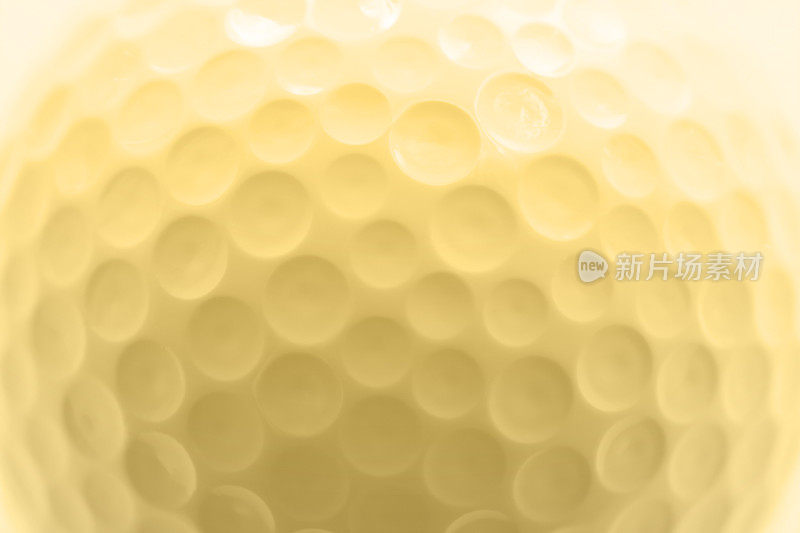 高尔夫球纹理，微距摄影，柔和的金色色彩效果。