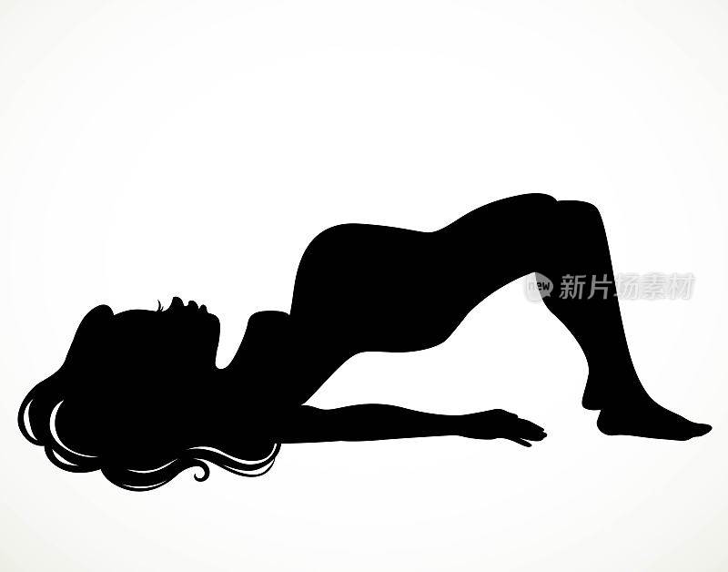 一个美丽的孕妇做瑜伽训练的黑色剪影