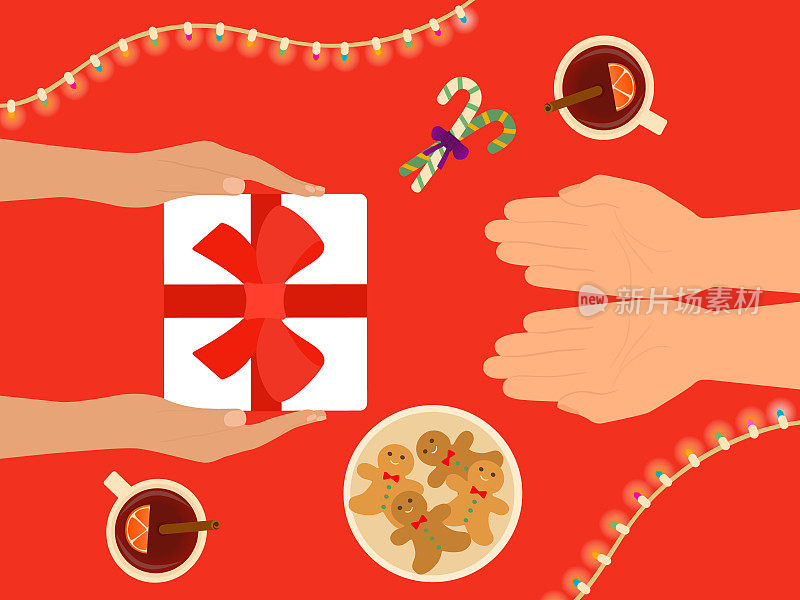 双手赠送礼物和庆祝圣诞节。桌上有热葡萄酒，姜饼饼干和拐杖糖