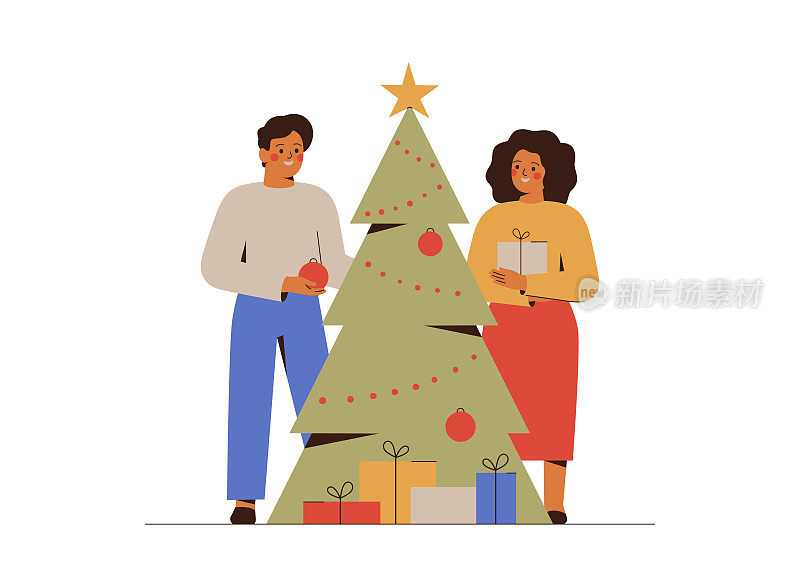 年轻夫妇准备圣诞假期和装饰圣诞树。一家人聚在一起庆祝杉树。