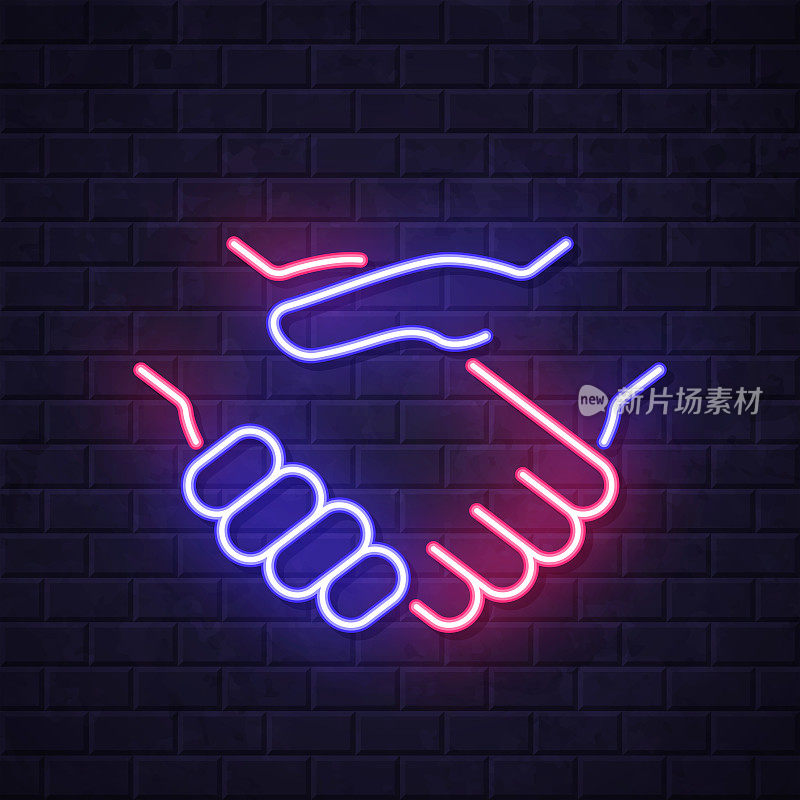 握手。在砖墙背景上发光的霓虹灯图标