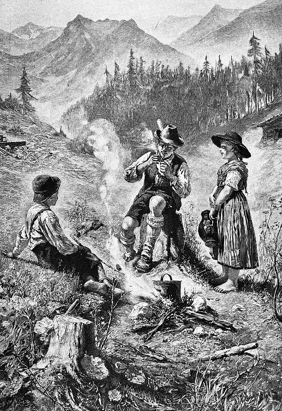 一个男人和两个孩子在森林里休息，在壁炉边做饭