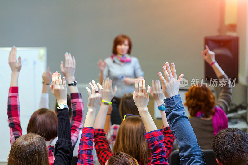 积极的学生举起手臂准备回答老师的问题