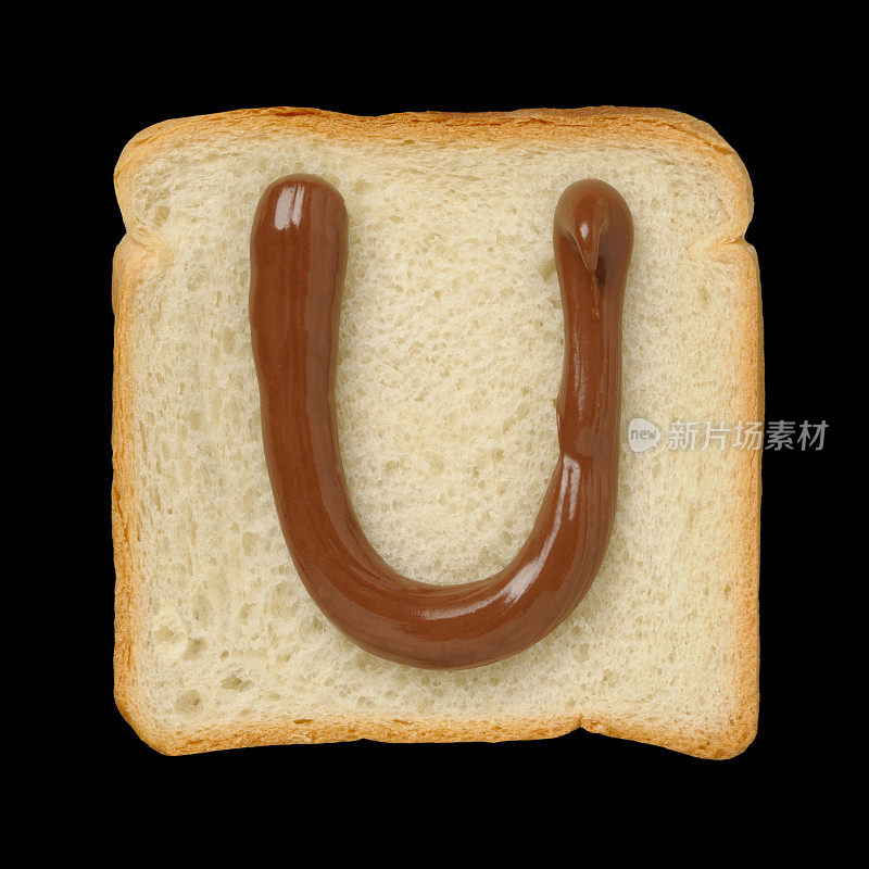巧克力字母U在锡箔面包片，黑色背景