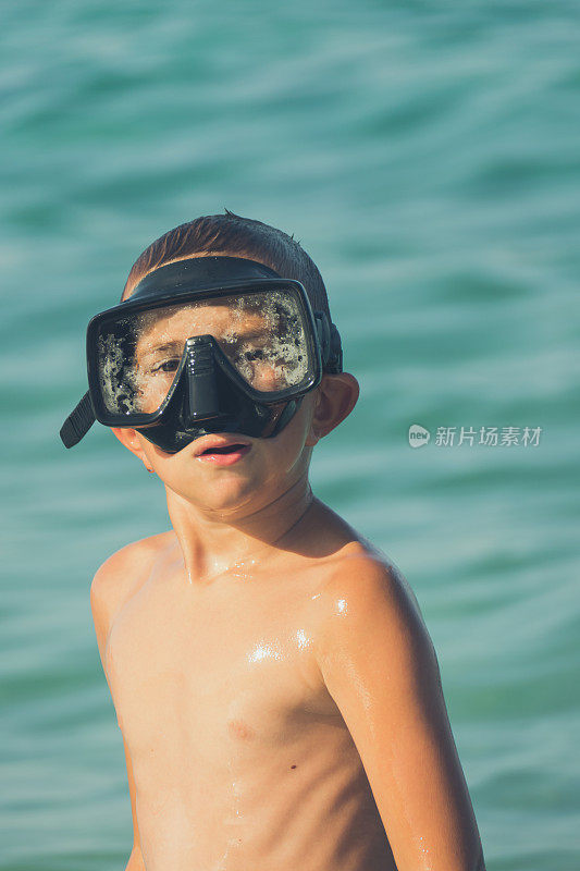 男孩在海水里戴着潜水面罩