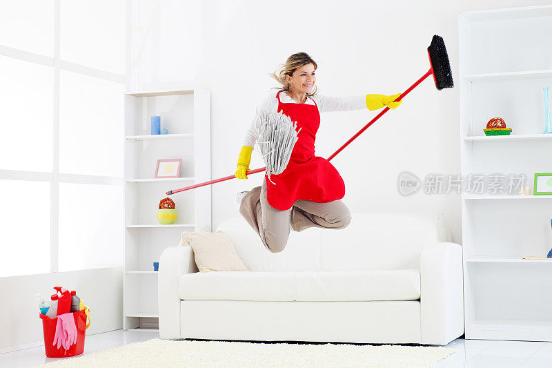 快乐的清洁工拿着扫帚和拖把跳来跳去。
