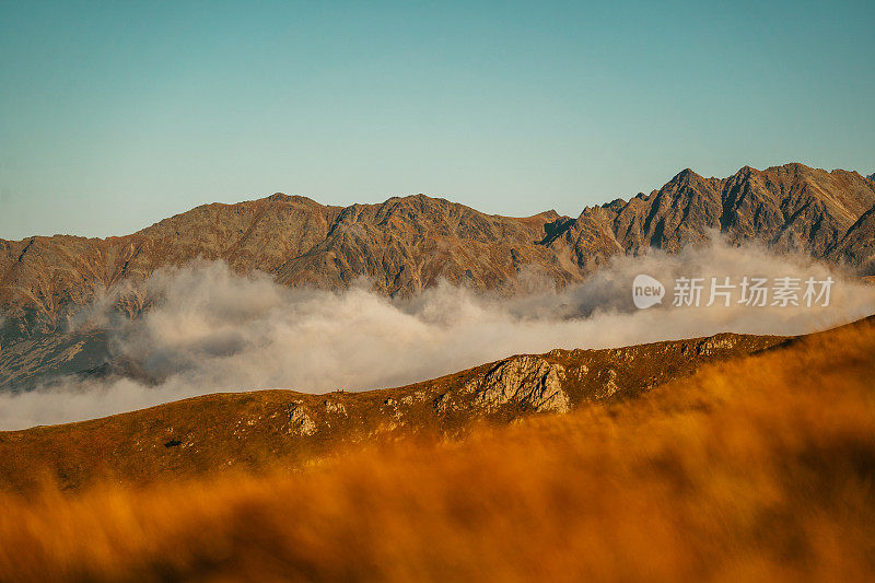 塔特拉山脉和阳光的秋景。云朵飘浮于山峰之上