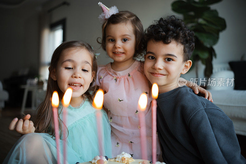 过生日的小孩在家里吹灭蛋糕上的蜡烛