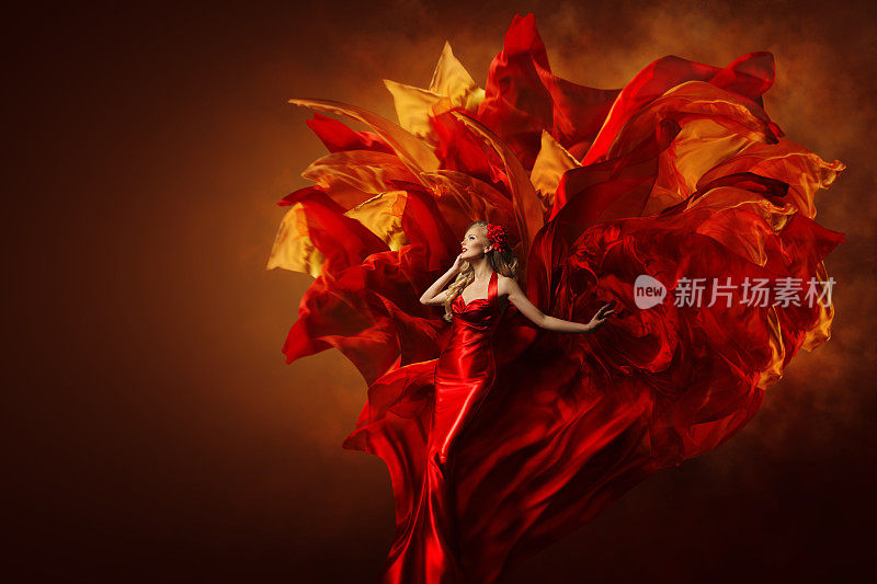 女人艺术连衣裙，美丽的时装模特在艺术红色长袍，挥舞飞舞的织物爆炸
