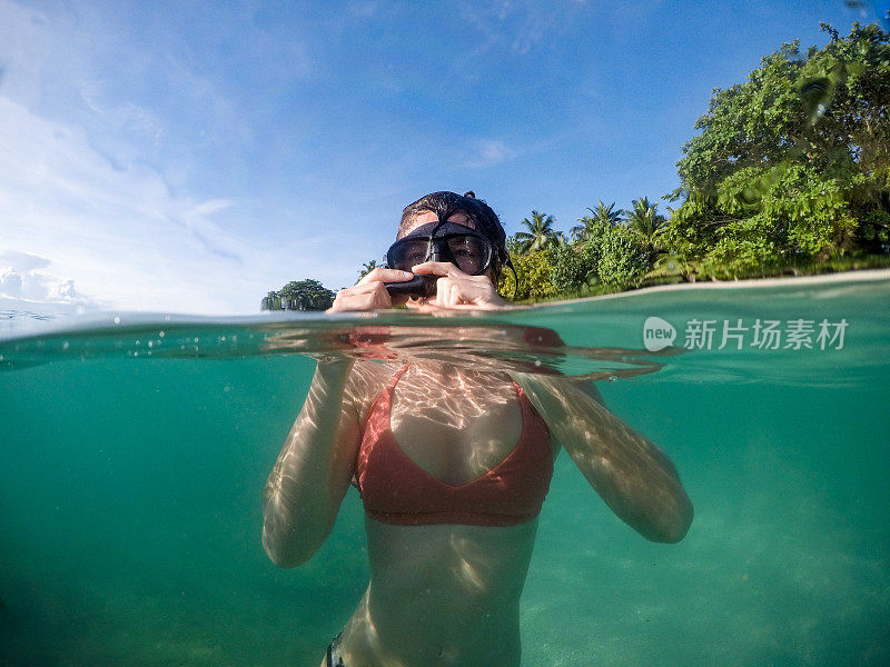 妇女戴着水肺面罩和通气管在热带海洋