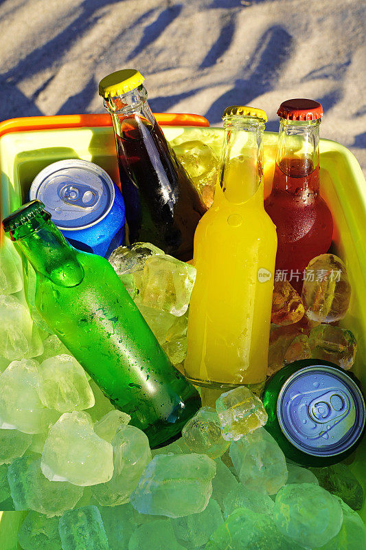 沙滩上的冷藏箱里装着五颜六色的苏打饮料和装满冰块。