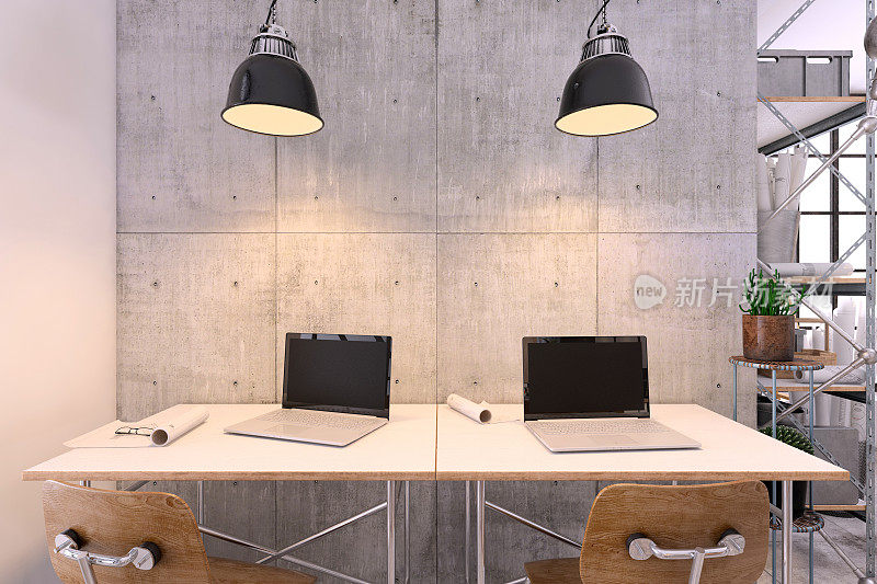 小型现代办公室内，配有配有笔记本电脑和灯光的大办公桌
