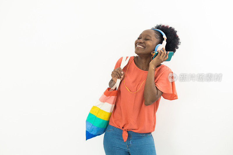 一个快乐的年轻非洲女人的肖像，听着她最喜欢的音乐