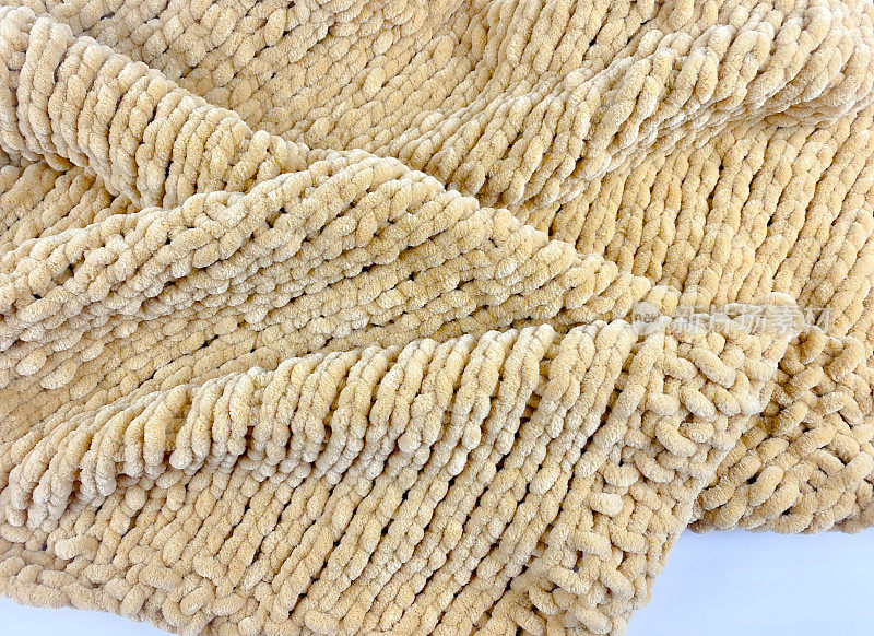 编织背景:手工编织柔软厚实的雪尼尔绒毯