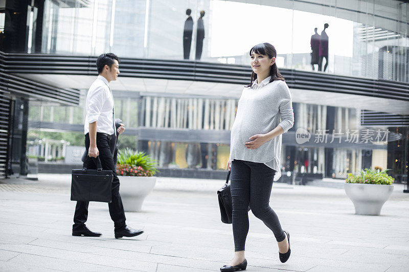 怀孕的商务女士行走