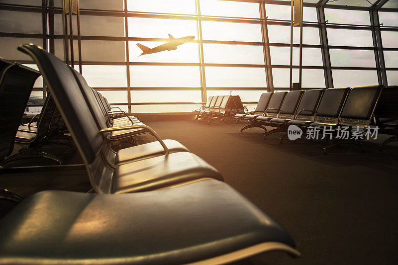 机场航站楼的空椅子和爆裂的灯光，外面的飞机登机作为背景