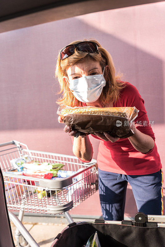 一名妇女在冠状病毒大流行期间戴着口罩购物