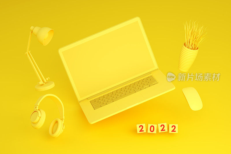 2022年新年，黄色背景的黑屏笔记本电脑