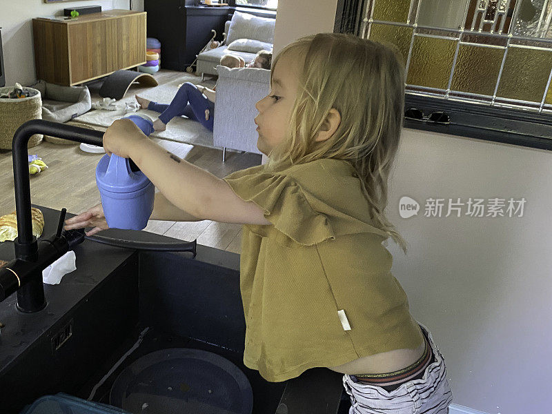 蹒跚学步的小女孩在洒花