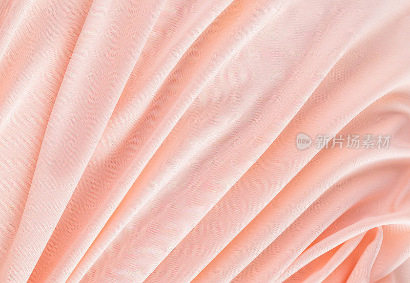优雅的桃色纺织背景与柔软的褶皱。喜庆的背景颜色是2024年的桃色绒毛。一个拷贝空间。