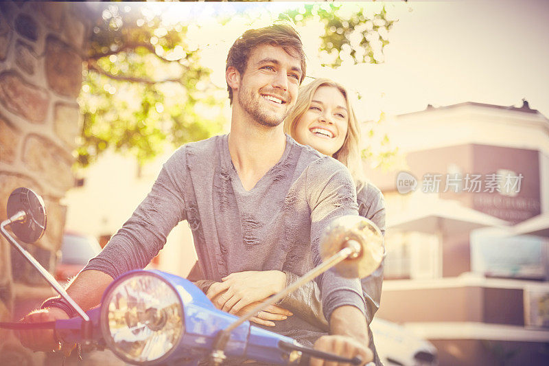 一对夫妇骑着时髦的摩托车看向别处