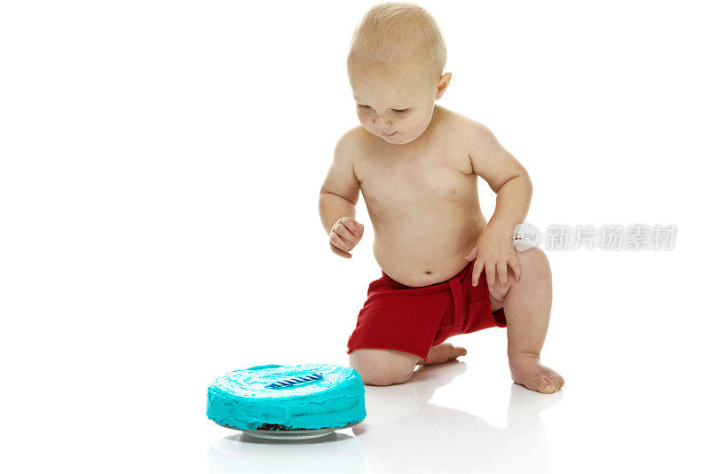小男孩在看他的第一个生日蛋糕