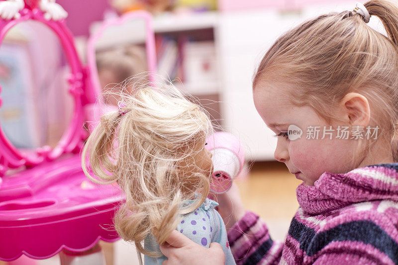 小女孩在玩她的洋娃娃