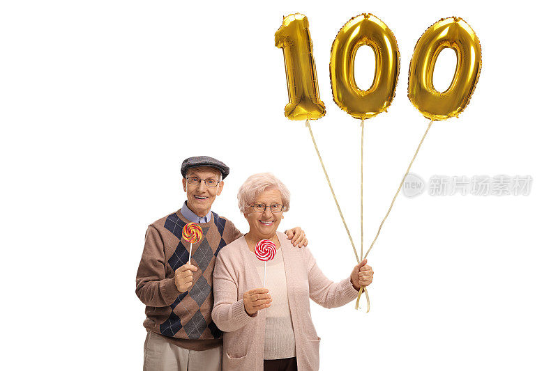 拿着棒棒糖和金色数字百气球的老夫妇