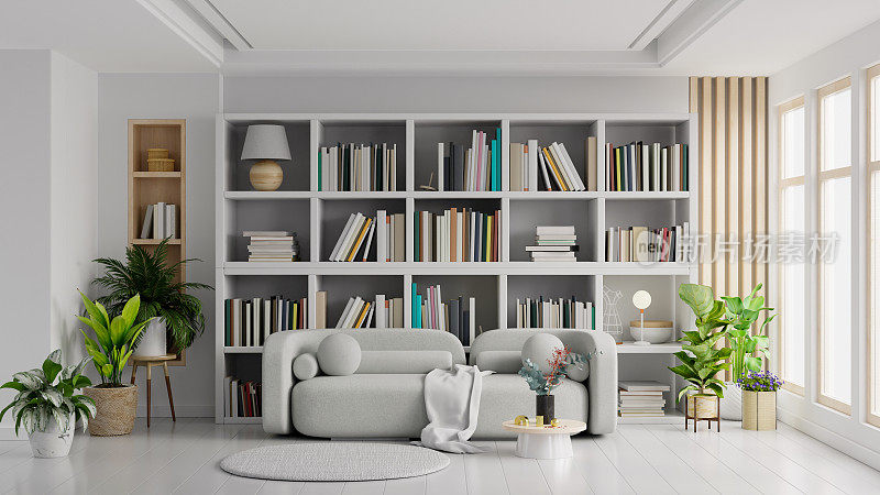 书房里的客厅用灰色沙发搭在空的浅白色墙上。