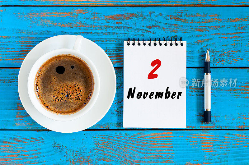 11月2日。去年秋月的第二天。日历上有老师早上咖啡杯，学生工作的背景。俯视图