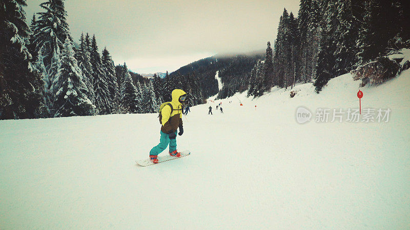 在雪道上玩滑雪板